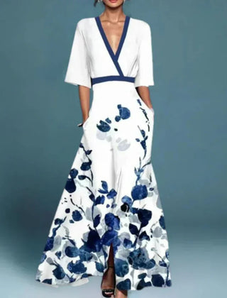 Hazel floral maxi dress by THE WHITMORE FAMILY featuring a belted waist and V-neck, with a vibrant red floral pattern.