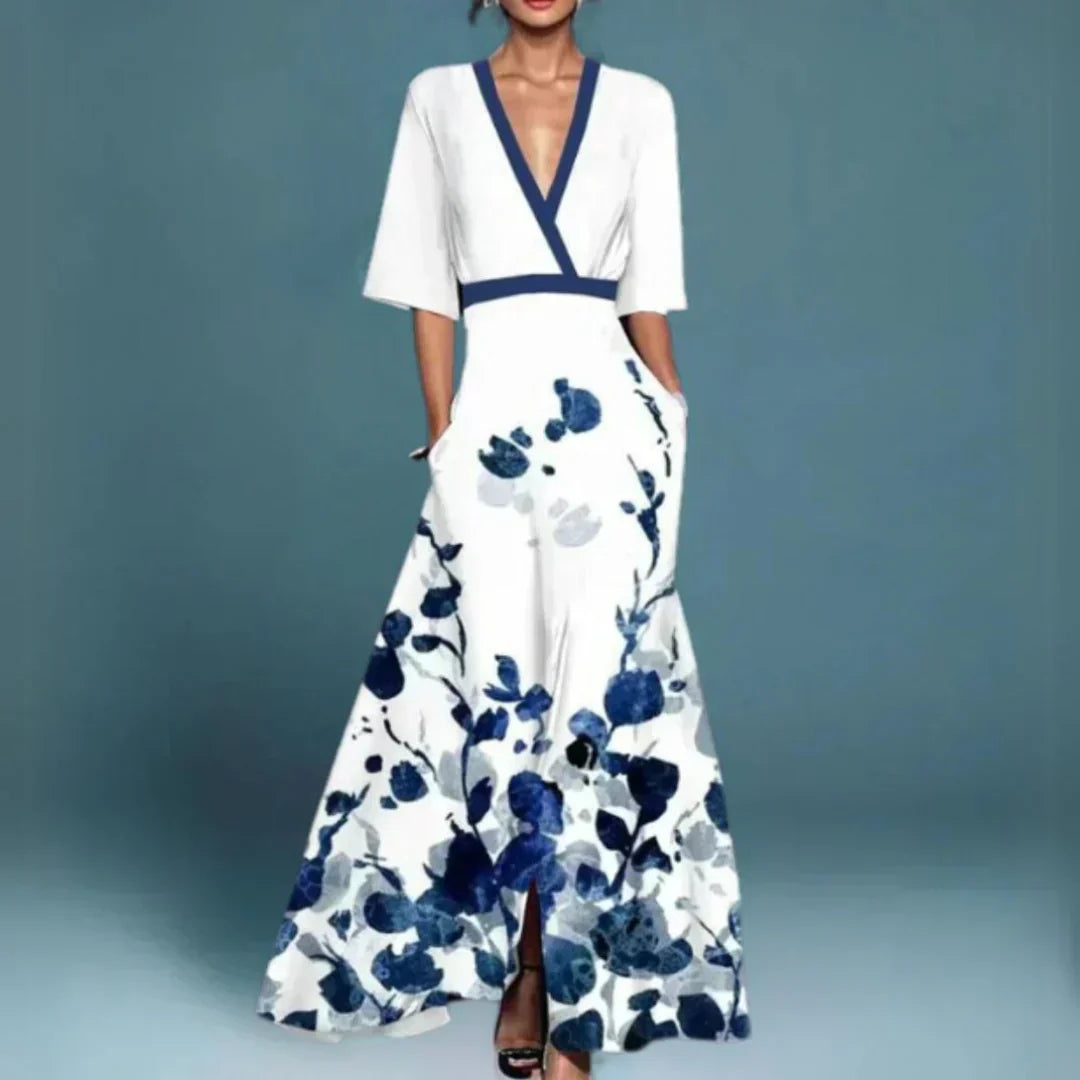 Hazel floral maxi dress by THE WHITMORE FAMILY featuring a belted waist and V-neck, with a vibrant red floral pattern.