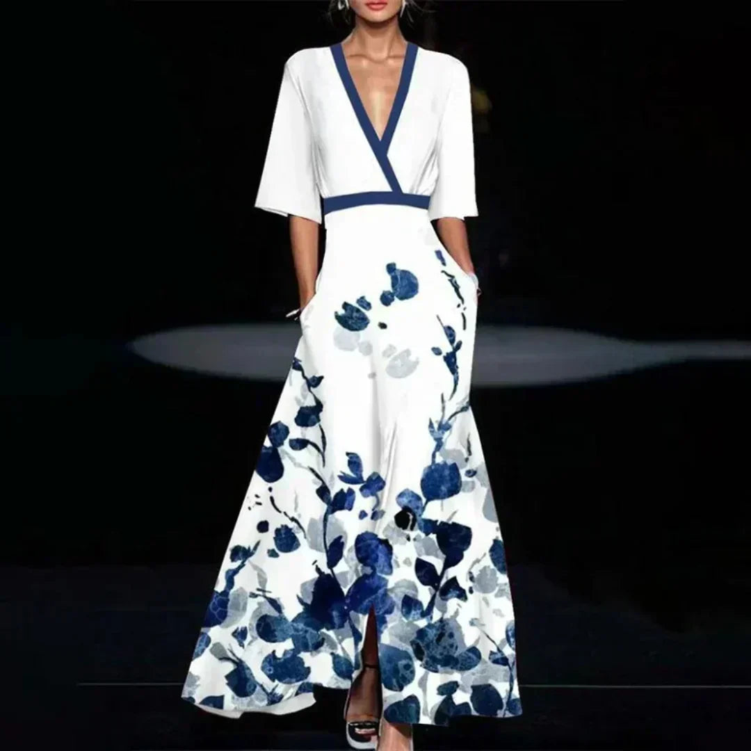 Hazel floral maxi dress by THE WHITMORE FAMILY featuring a belted waist and V-neck, with vibrant red and floral pattern.