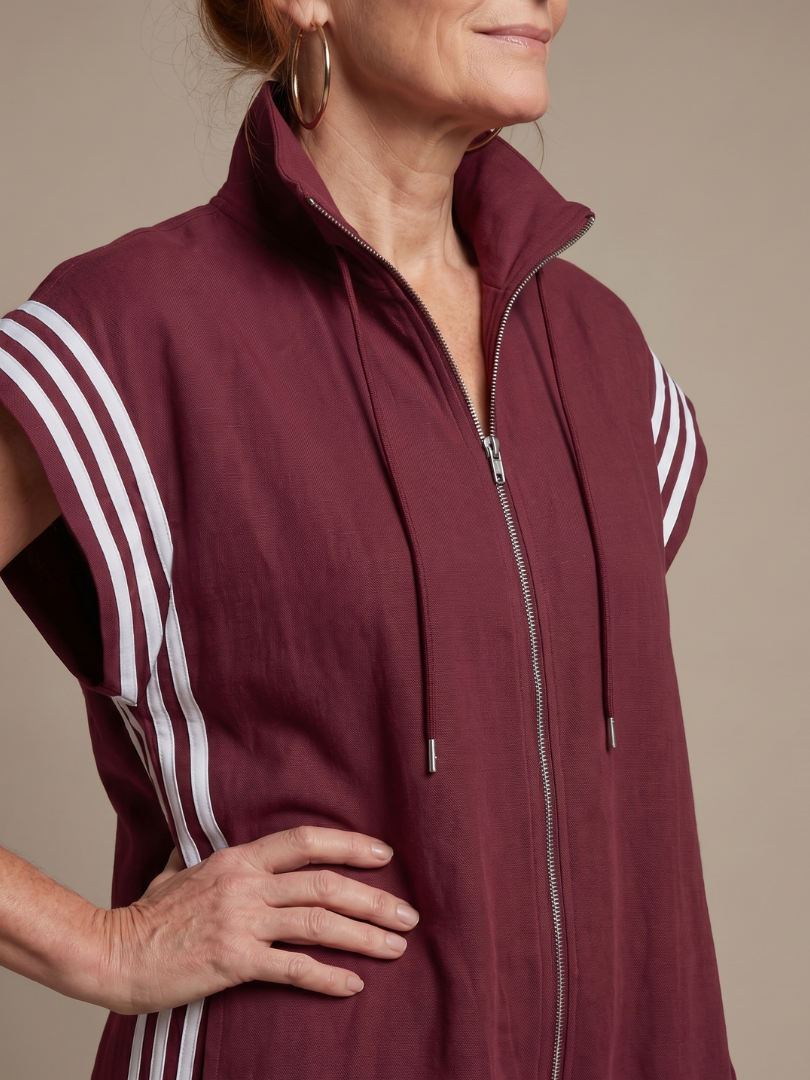 Red Lark zip-front stripe panel jumpsuit by THE WHITMORE FAMILY, showcasing a stylish, fitted design with a front zipper and bold stripe details.