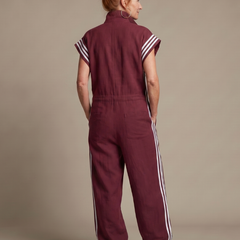 Red Lark zip front stripe panel jumpsuit by THE WHITMORE FAMILY, featuring a stylish front zipper and bold stripe design.