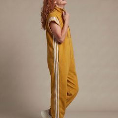 Red THE WHITMORE FAMILY Lark zip-front stripe panel jumpsuit displayed on a model, showcasing its stylish design and fit.