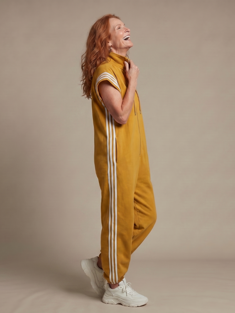 Red THE WHITMORE FAMILY Lark zip-front stripe panel jumpsuit displayed on a model, showcasing its stylish design and fit.