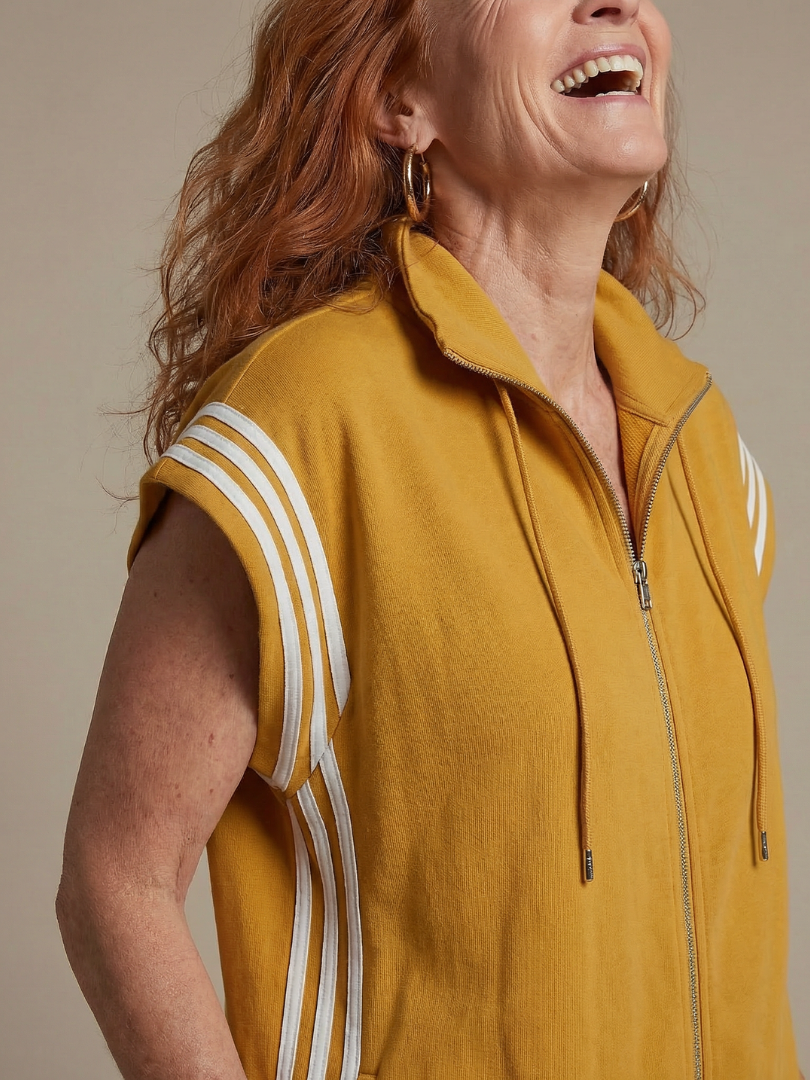 Red THE WHITMORE FAMILY Lark zip front stripe panel jumpsuit displayed on a hanger with a fitted silhouette and bold stripe details.