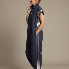 Red Lark Zip Front Stripe Panel Jumpsuit by THE WHITMORE FAMILY, featuring a front zipper and stylish striped design.