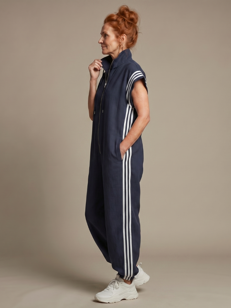 Red Lark Zip Front Stripe Panel Jumpsuit by THE WHITMORE FAMILY, featuring a front zipper and stylish striped design.