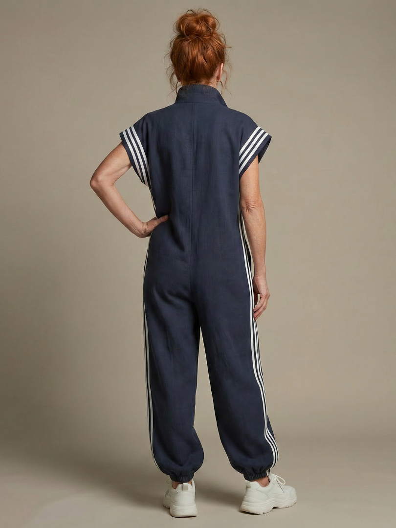 Red Lark Zip Front Stripe Panel Jumpsuit by THE WHITMORE FAMILY, featuring a front zipper and bold stripe design.