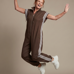 Red Lark Zip Front Stripe Panel Jumpsuit by THE WHITMORE FAMILY, featuring a fitted design and bold stripe details.