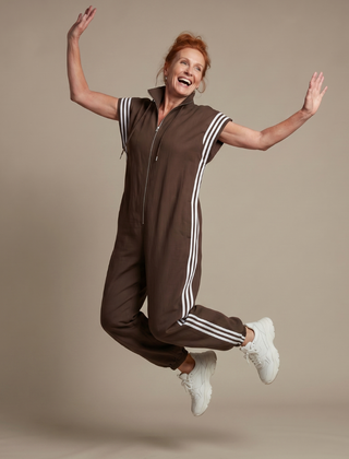Red Lark Zip Front Stripe Panel Jumpsuit by THE WHITMORE FAMILY, featuring a fitted design and bold stripe details.
