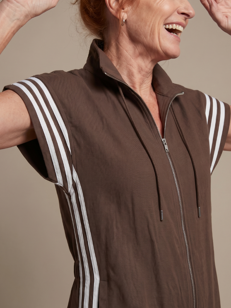 Red Lark zip-front stripe panel jumpsuit by THE WHITMORE FAMILY, featuring a fitted silhouette and bold stripe design.