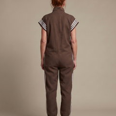 Red Lark zip-front stripe panel jumpsuit by THE WHITMORE FAMILY, featuring a stylish front zipper and contrasting stripe details.