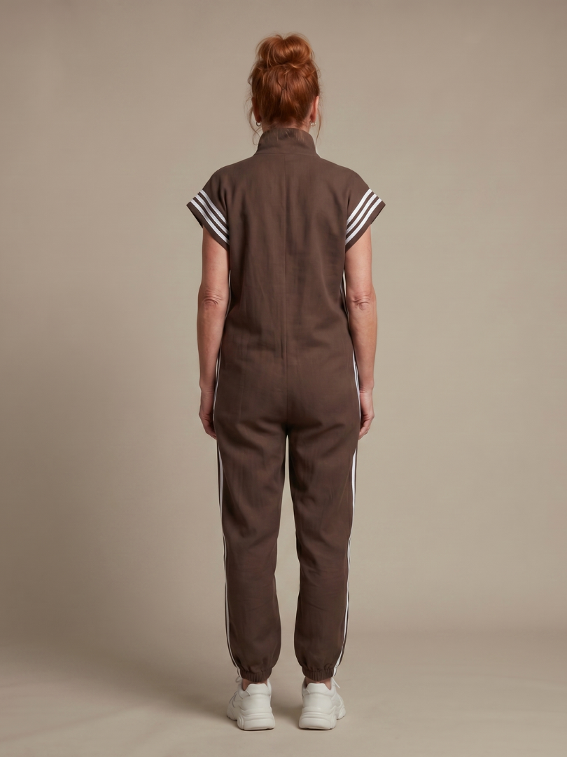 Red Lark zip-front stripe panel jumpsuit by THE WHITMORE FAMILY, featuring a stylish front zipper and contrasting stripe details.