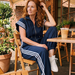Red Lark zip front stripe panel jumpsuit by THE WHITMORE FAMILY, featuring a modern design and stylish fit.