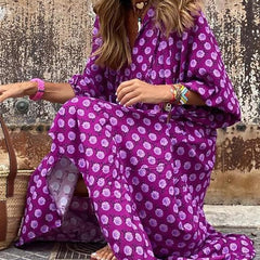 Nina floral boho maxi dress by THE WHITMORE FAMILY, featuring a vibrant red floral pattern and flowing silhouette.
