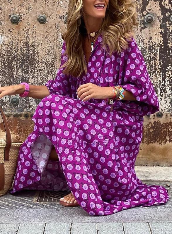Nina floral boho maxi dress by THE WHITMORE FAMILY, featuring a vibrant red floral pattern and flowing silhouette.