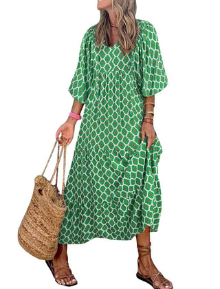 Nina floral boho maxi dress by THE WHITMORE FAMILY featuring a vibrant red floral pattern and flowing silhouette.