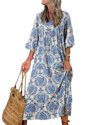 Nina floral boho maxi dress by THE WHITMORE FAMILY, featuring a vibrant floral pattern, flowing fabric, and bohemian style.