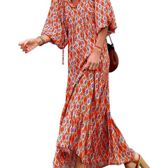 Red floral boho maxi dress by THE WHITMORE FAMILY, featuring a flowing silhouette and vibrant floral pattern.