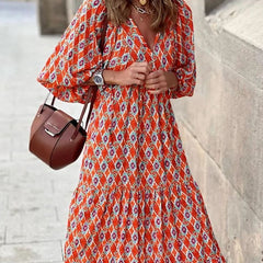 Nina floral boho maxi dress by THE WHITMORE FAMILY, featuring a vibrant red floral pattern and flowing silhouette.