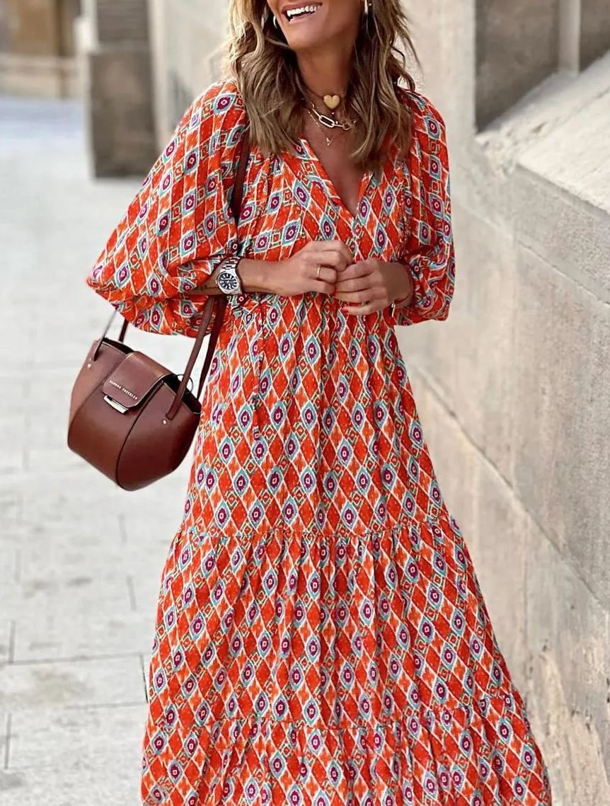 Nina floral boho maxi dress by THE WHITMORE FAMILY, featuring a vibrant red floral pattern and flowing silhouette.