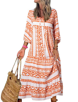 Nina floral boho maxi dress by THE WHITMORE FAMILY featuring vibrant red and colorful floral patterns, flowing fabric, and bohemian style.