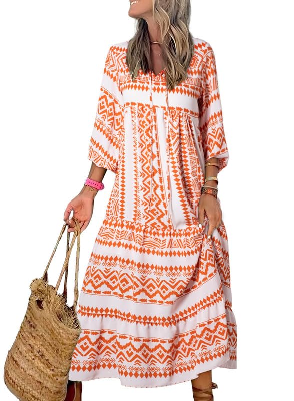 Nina floral boho maxi dress by THE WHITMORE FAMILY featuring vibrant red and colorful floral patterns, flowing fabric, and bohemian style.