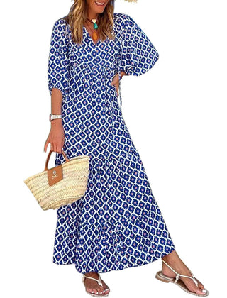 Nina floral boho maxi dress by THE WHITMORE FAMILY featuring a vibrant red floral pattern and flowing silhouette.