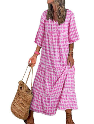 Nina floral boho maxi dress by THE WHITMORE FAMILY, featuring a vibrant red floral pattern and flowing silhouette.