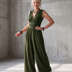 Vincenza wide-leg jumpsuit by THE WHITMORE FAMILY featuring a deep V neckline and waist definition in vibrant red fabric.