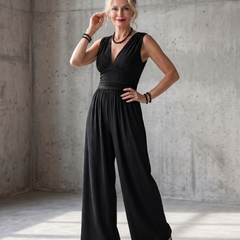 Vincenza deep V waist wide-leg jumpsuit by THE WHITMORE FAMILY, featuring a fitted waist and flowing wide-leg design.
