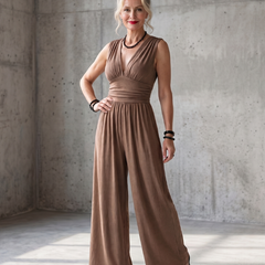 Vincenza deep V waist wide-leg jumpsuit by THE WHITMORE FAMILY, featuring a stylish red fabric and a flattering silhouette.