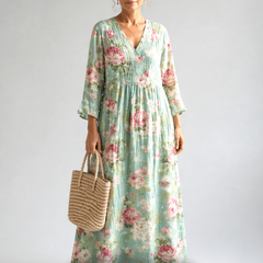 Anne printed summer dress by THE WHITMORE FAMILY, featuring a flowy fabric with colorful floral patterns and a sleeveless design.