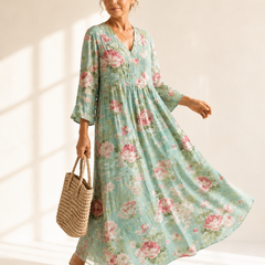 Anne printed summer dress by THE WHITMORE FAMILY, featuring a colorful floral pattern and lightweight fabric, perfect for warm weather.