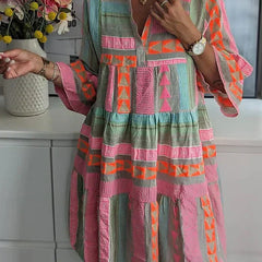 A woman wearing the Ava chic V-neck hemp summer dress by THE WHITMORE FAMILY, showcasing its relaxed fit and natural fabric.