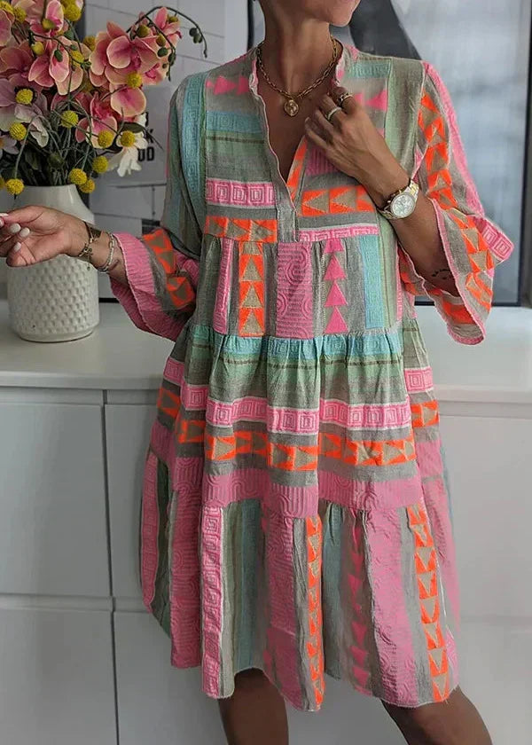 A woman wearing the Ava chic V-neck hemp summer dress by THE WHITMORE FAMILY, showcasing its relaxed fit and natural fabric.