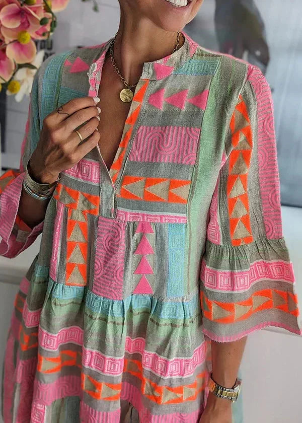 A woman wearing the Ava chic V-neck hemp summer dress by THE WHITMORE FAMILY, showcasing a flowy, natural fabric design perfect for warm weather.