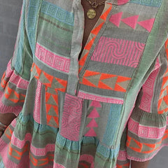 A woman wearing the Ava chic V-neck hemp summer dress by THE WHITMORE FAMILY, featuring a breezy, relaxed fit and natural hemp fabric.