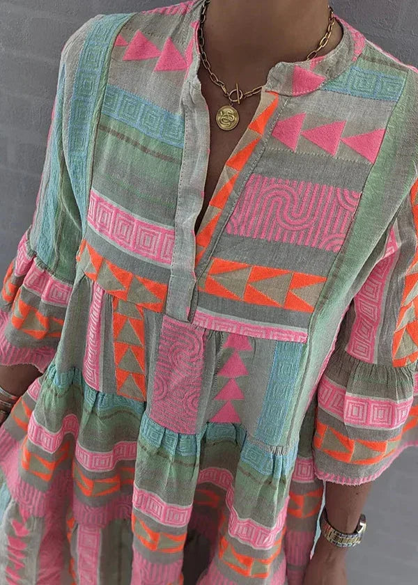 A woman wearing the Ava chic V-neck hemp summer dress by THE WHITMORE FAMILY, featuring a breezy, relaxed fit and natural hemp fabric.