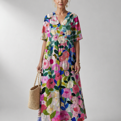 Vintage flower dress by THE WHITMORE FAMILY, Bente style featuring a floral pattern and classic design, displayed on a hanger.