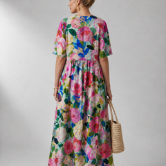 Bente vintage flower dress by THE WHITMORE FAMILY displayed on a hanger, showcasing floral pattern and classic style.