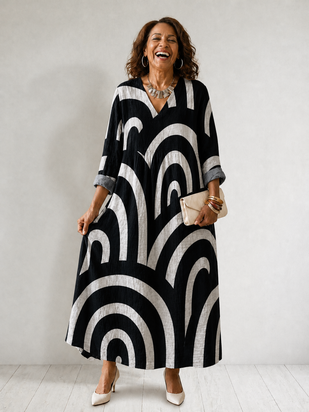 Cynthia Summer Breeze Printed Dress by THE WHITMORE FAMILY displayed on a hanger with floral and colorful patterns.