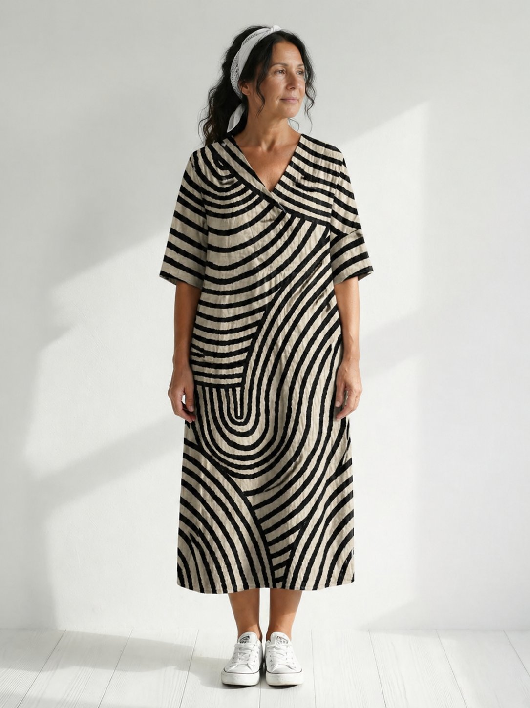 Jinte graphic dress by THE WHITMORE FAMILY featuring bold, colorful abstract patterns and a relaxed fit on a model.