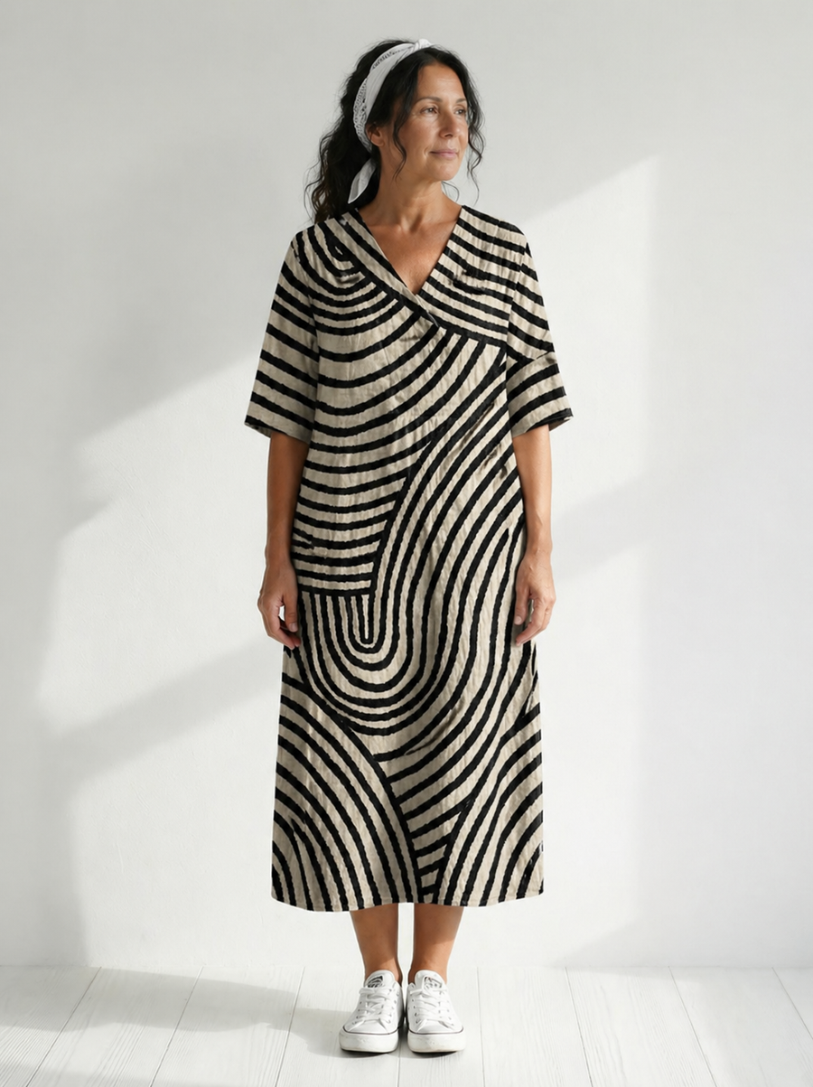 Jinte graphic dress by THE WHITMORE FAMILY featuring bold, colorful abstract patterns and a relaxed fit on a model.