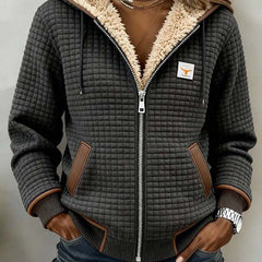 Silvana Sherpa-lined quilted zip-up hooded jacket by THE WHITMORE FAMILY, showcasing its cozy sherpa lining and quilted exterior.
