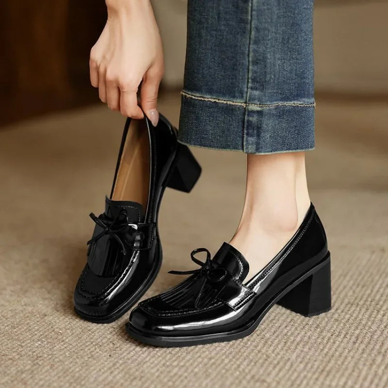 Black Dorothy loafer pumps by THE WHITMORE FAMILY featuring a stylish sandal design and comfortable slip-on style.