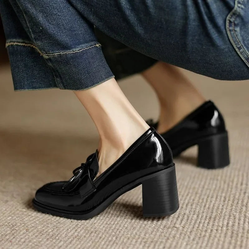 Black Dorothy loafer pumps by THE WHITMORE FAMILY, stylish sandal design with slip-on loafer features.