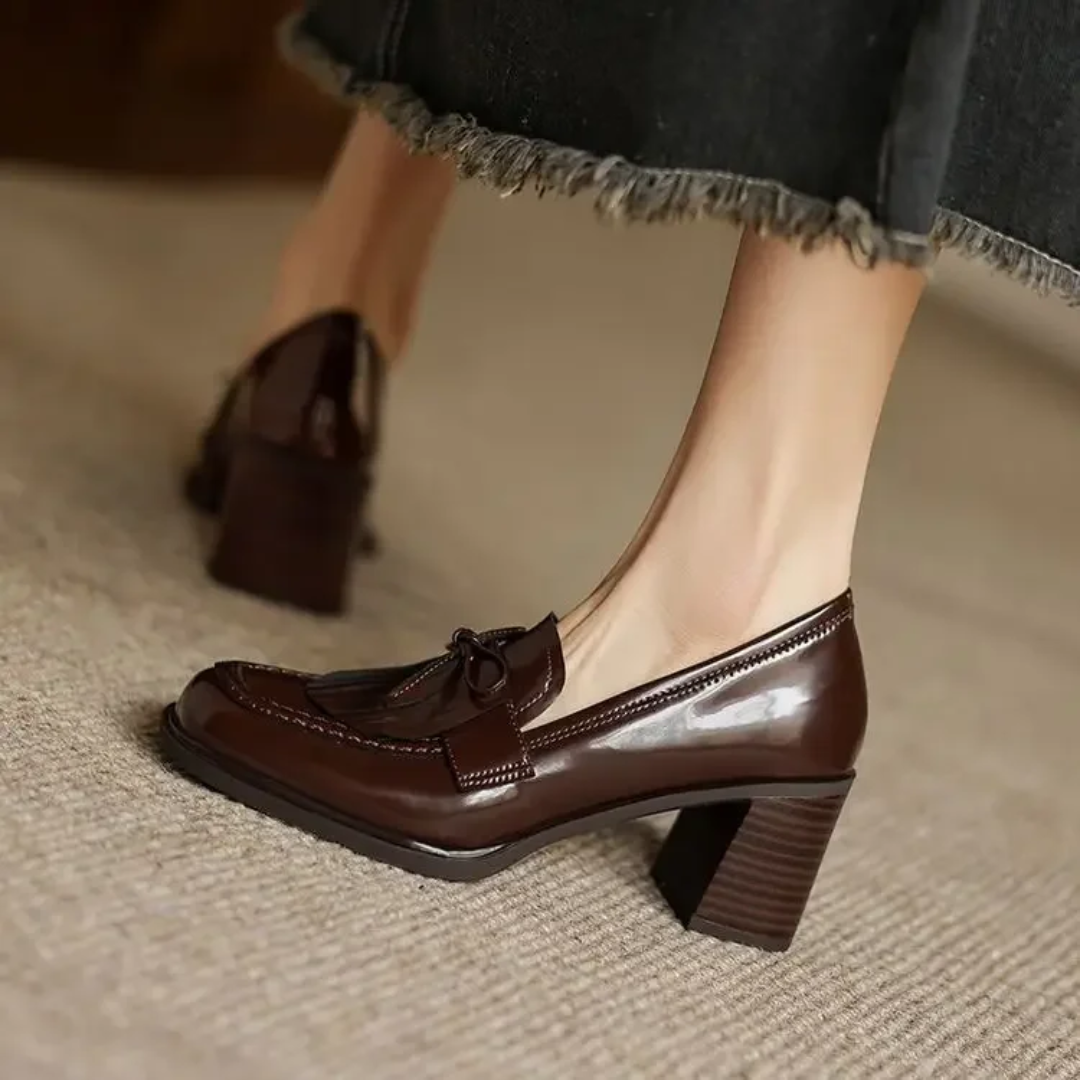Black Dorothy loafer pumps from THE WHITMORE FAMILY, stylish sandal design with a comfortable slip-on fit.