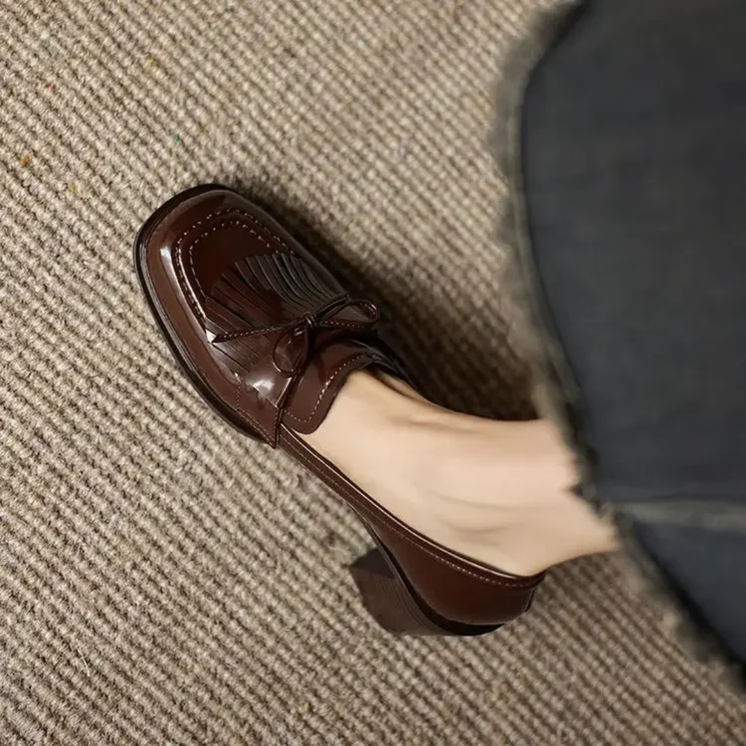 Black Dorothy loafer pumps by THE WHITMORE FAMILY featuring a sleek sandal design, stylish and comfortable for everyday wear.