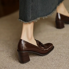 Black Dorothy loafer pumps from THE WHITMORE FAMILY featuring a sleek sandal design and classic slip-on style.