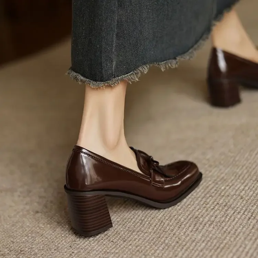 Black Dorothy loafer pumps from THE WHITMORE FAMILY featuring a sleek sandal design and classic slip-on style.